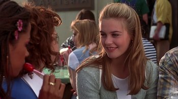 Movie still from “Clueless” (1995), directed by Amy Heckerling – Two young women are smiling at each other; Close Up shot, Over the shoulder angle