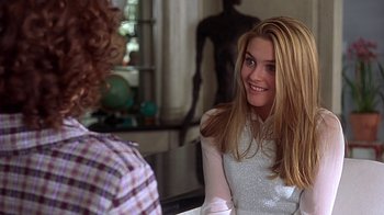 Movie still from “Clueless” (1995), directed by Amy Heckerling – A woman sitting in front of another woman in front of a mirror; Close Up shot, Over the shoulder angle