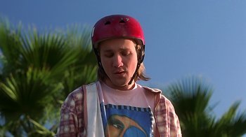 Movie still from “Clueless” (1995), directed by Amy Heckerling – A person wearing a helmet and holding a towel; Close Up shot, Low angle