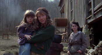 Movie still from “Coal Miner's Daughter” (1980), directed by Michael Apted – Two women and a child in a wooded area; Medium shot, Low angle