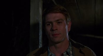 Movie still from “Coal Miner's Daughter” (1980), directed by Michael Apted – A person wearing a plaid shirt; Close Up shot, Over the shoulder angle