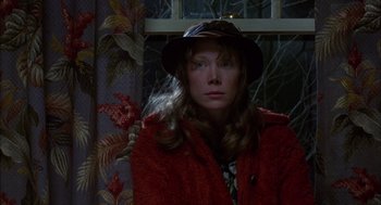 Movie still from “Coal Miner's Daughter” (1980), directed by Michael Apted – A woman wearing a hat and a red coat; Close Up shot, High angle