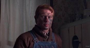 Movie still from “Coal Miner's Daughter” (1980), directed by Michael Apted – A man with blue paint on his face and head; Close Up shot, Over the shoulder angle