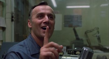 Movie still from “Coal Miner's Daughter” (1980), directed by Michael Apted – A man with his finger on his mouth; Close Up shot, Over the shoulder angle