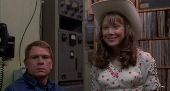 Movie still from “Coal Miner's Daughter” (1980), directed by Michael Apted – A man and a woman wearing cowboy hats; Medium shot, Over the shoulder angle