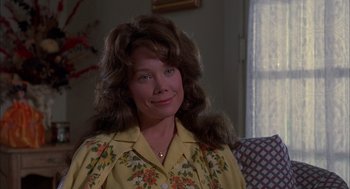 Movie still from “Coal Miner's Daughter” (1980), directed by Michael Apted – A person sitting on a couch; Close Up shot, Low angle