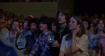 Movie still from “Coal Miner's Daughter” (1980), directed by Michael Apted – A group of young men and women sitting in a room; Medium shot, High angle