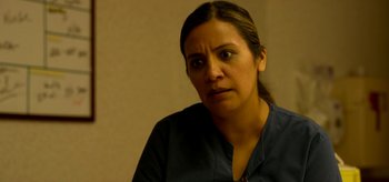 Movie still from “Coast” (2021), directed by Derek Schweickart – A person wearing a blue shirt; Close Up shot, Over the shoulder angle