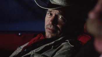 Movie still from “Cockfighter” (1974), directed by Monte Hellman – A person wearing a cowboy hat; Close Up shot, Low angle