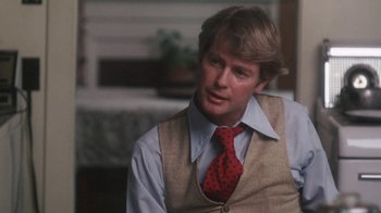 Movie still from “Cockfighter” (1974), directed by Monte Hellman – A man wearing a vest and a red tie; Close Up shot, Over the shoulder angle