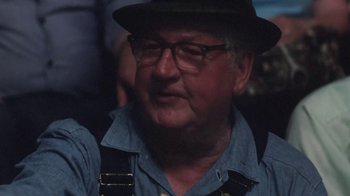 Movie still from “Cockfighter” (1974), directed by Monte Hellman – An older man wearing glasses and a hat; Close Up shot, Over the shoulder angle