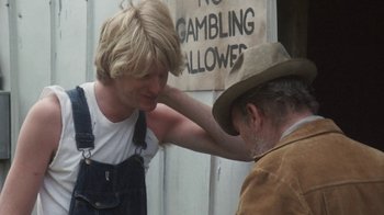 Movie still from “Cockfighter” (1974), directed by Monte Hellman – A man with his hand on another man's shoulder; Medium shot, Over the shoulder angle