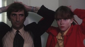 Movie still from “Cockfighter” (1974), directed by Monte Hellman – A man and a woman standing next to each other in a room; Close Up shot, Low angle