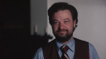 Movie still from “Cockfighter” (1974), directed by Monte Hellman – A person wearing a vest and a tie; Close Up shot, High angle