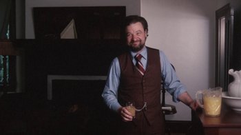 Movie still from “Cockfighter” (1974), directed by Monte Hellman – A man holding a drink in his right hand; Medium shot, Low angle