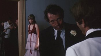 Movie still from “Cockfighter” (1974), directed by Monte Hellman – A man and a woman standing next to each other in front of a mirror; Medium shot, Over the shoulder angle