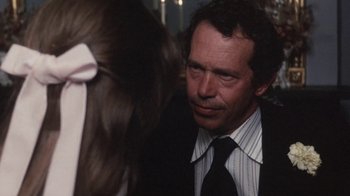 Movie still from “Cockfighter” (1974), directed by Monte Hellman – A person wearing a suit and tie; Close Up shot, Over the shoulder angle