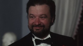 Movie still from “Cockfighter” (1974), directed by Monte Hellman – A person wearing a suit and a bow tie; Close Up shot, High angle