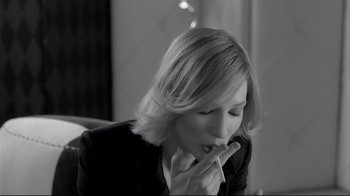 Movie still from “Coffee and Cigarettes” (2003), directed by Jim Jarmusch – A black and white photo of a woman smoking a cigarette; Close Up shot, Over the shoulder angle