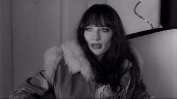 Movie still from “Coffee and Cigarettes” (2003), directed by Jim Jarmusch – A black and white photo of a woman in a fur coat; Close Up shot, High angle