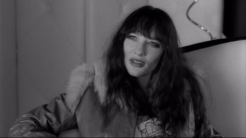 Movie still from “Coffee and Cigarettes” (2003), directed by Jim Jarmusch – A black and white photo of a woman with long dark hair; Close Up shot, High angle