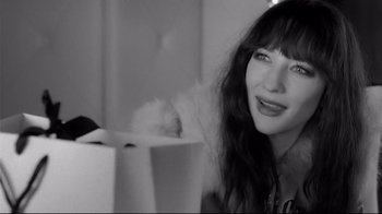 Movie still from “Coffee and Cigarettes” (2003), directed by Jim Jarmusch – A black - and - white photo of a woman smiling; Close Up shot, Over the shoulder angle