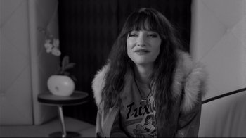 Movie still from “Coffee and Cigarettes” (2003), directed by Jim Jarmusch – A black and white photo of a woman with long brown hair; Close Up shot, Over the shoulder angle