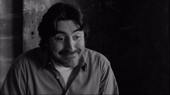 Movie still from “Coffee and Cigarettes” (2003), directed by Jim Jarmusch – Black and white photograph of a man with a beard; Close Up shot, Low angle