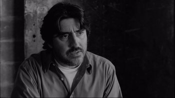 Movie still from “Coffee and Cigarettes” (2003), directed by Jim Jarmusch – Black and white photograph of a man with long hair; Close Up shot, Low angle