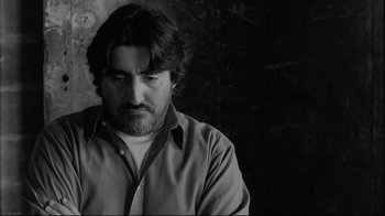 Movie still from “Coffee and Cigarettes” (2003), directed by Jim Jarmusch – Black and white photograph of a man with a beard; Close Up shot, Low angle