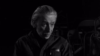 Movie still from “Coffee and Cigarettes” (2003), directed by Jim Jarmusch – An older man with a short hair style; Close Up shot, Over the shoulder angle