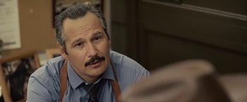 Movie still from “Cold in July” (2014), directed by Jim Mickle – A person wearing a shirt and a tie; Close Up shot, Over the shoulder angle