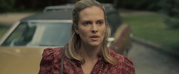 Movie still from “Cold in July” (2014), directed by Jim Mickle – A person with long blonde hair; Close Up shot, Over the shoulder angle