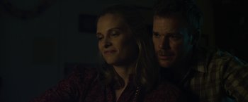 Movie still from “Cold in July” (2014), directed by Jim Mickle – A man and a woman sitting next to each other in the dark; Close Up shot, Low angle