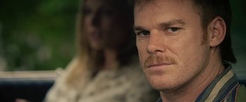 Movie still from “Cold in July” (2014), directed by Jim Mickle – A person with a mustache; Close Up shot, Over the shoulder angle