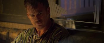 Movie still from “Cold in July” (2014), directed by Jim Mickle – A person wearing a striped shirt; Close Up shot, Over the shoulder angle