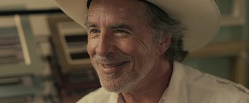 Movie still from “Cold in July” (2014), directed by Jim Mickle – An older man wearing a white cowboy hat; Close Up shot, Low angle