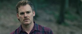 Movie still from “Cold in July” (2014), directed by Jim Mickle – A person wearing a plaid shirt; Close Up shot, Over the shoulder angle