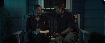Movie still from “Cold in July” (2014), directed by Jim Mickle – A man and a woman sitting next to each other; Medium shot, Over the shoulder angle