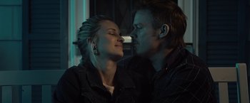Movie still from “Cold in July” (2014), directed by Jim Mickle – A man and a woman are kissing in a room; Close Up shot, Over the shoulder angle