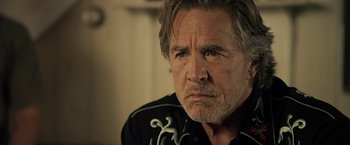 Movie still from “Cold in July” (2014), directed by Jim Mickle – An older man is looking at the camera; Close Up shot, Over the shoulder angle