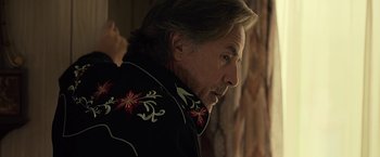 Movie still from “Cold in July” (2014), directed by Jim Mickle – A person wearing a jacket; Close Up shot, Over the shoulder angle