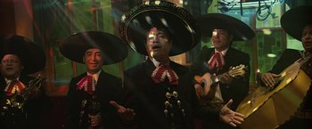 Movie still from “Cold in July” (2014), directed by Jim Mickle – A group of men in mariachi garb singing and playing instruments; Medium shot, Low angle