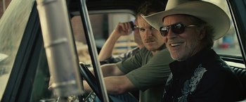Movie still from “Cold in July” (2014), directed by Jim Mickle – Two men sitting in the drivers seat of a truck; Close Up shot, Over the shoulder angle