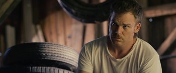 Movie still from “Cold in July” (2014), directed by Jim Mickle – A person wearing a white shirt; Close Up shot, Over the shoulder angle