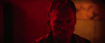 Movie still from “Cold in July” (2014), directed by Jim Mickle – A man in a dark room with red lighting; Close Up shot, Low angle