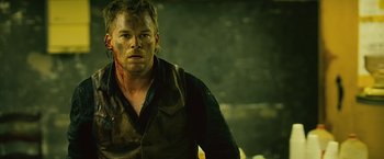 Movie still from “Cold in July” (2014), directed by Jim Mickle – A person wearing a black shirt; Close Up shot, Over the shoulder angle