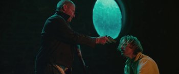 Movie still from “Cold in July” (2014), directed by Jim Mickle – An older man holding a gun up to a young woman's face; Medium shot, Over the shoulder angle