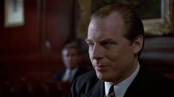 Movie still from “Coneheads” (1993), directed by Steve Barron – A man in a suit and tie; Close Up shot, Low angle