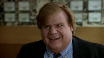 Movie still from “Coneheads” (1993), directed by Steve Barron – A person wearing a suit and tie; Close Up shot, Low angle